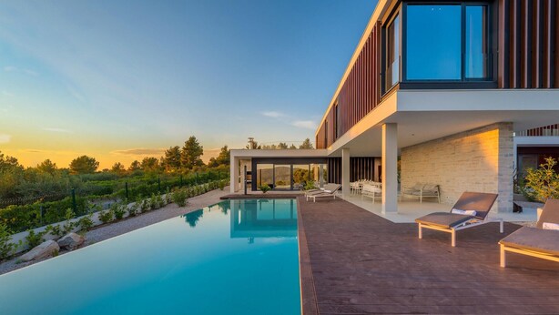 A modern house with a swimming pool, outdoor seating, and a view of the surrounding landscape. - Nice home in Primosten (Primosten)