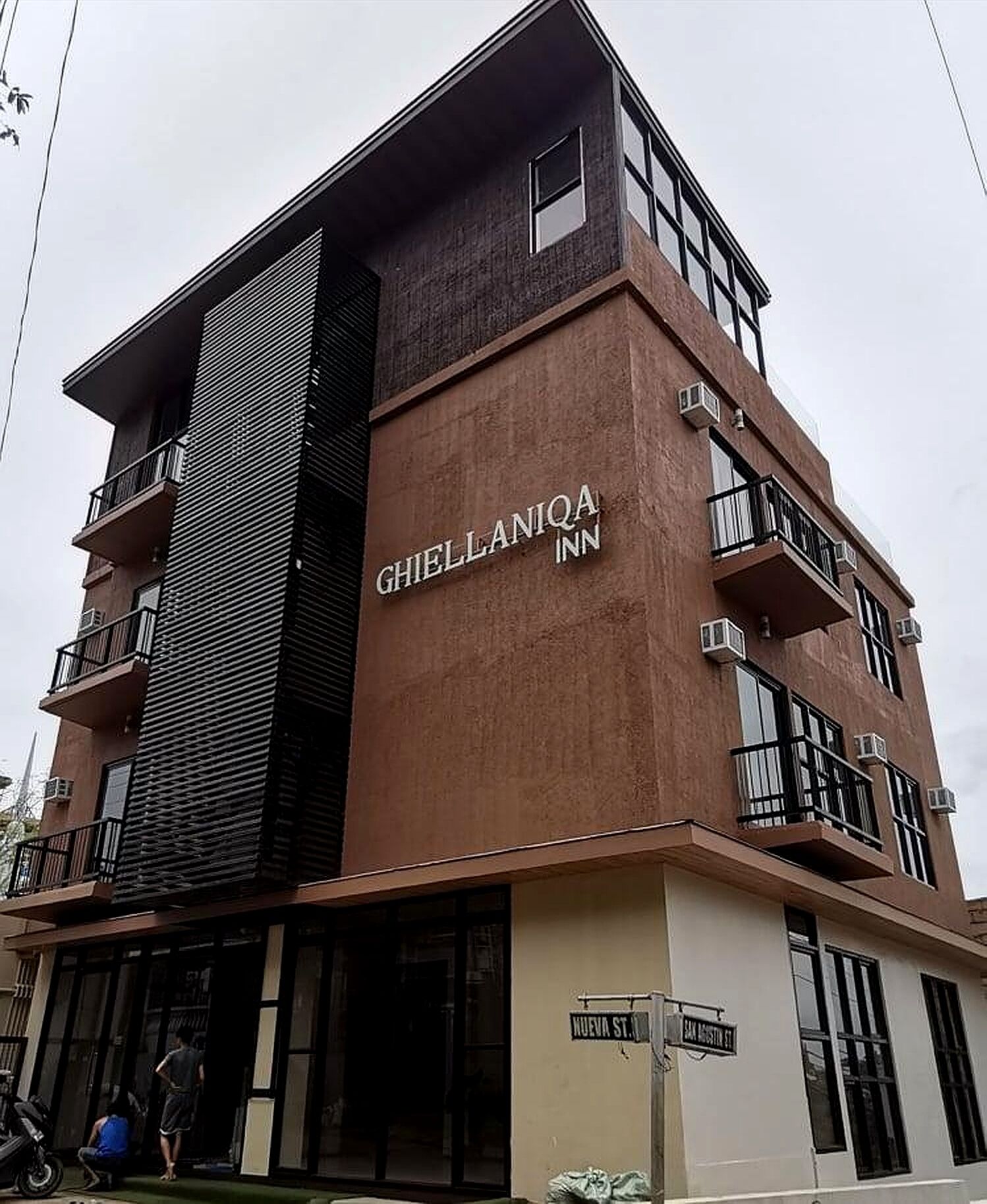 A multi-story building with the sign 'GHIELLANIA INN' on the facade.