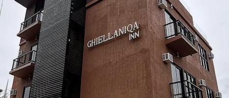 A multi-story building with the sign 'GHIELLANIA INN' on the facade.