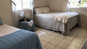 A bedroom with two beds, a bedside table with a lamp, and a window with curtains. - Craigmont Getaway
Get comfortable and enjoy plenty of space and cozy fireplace! (Craigmont)