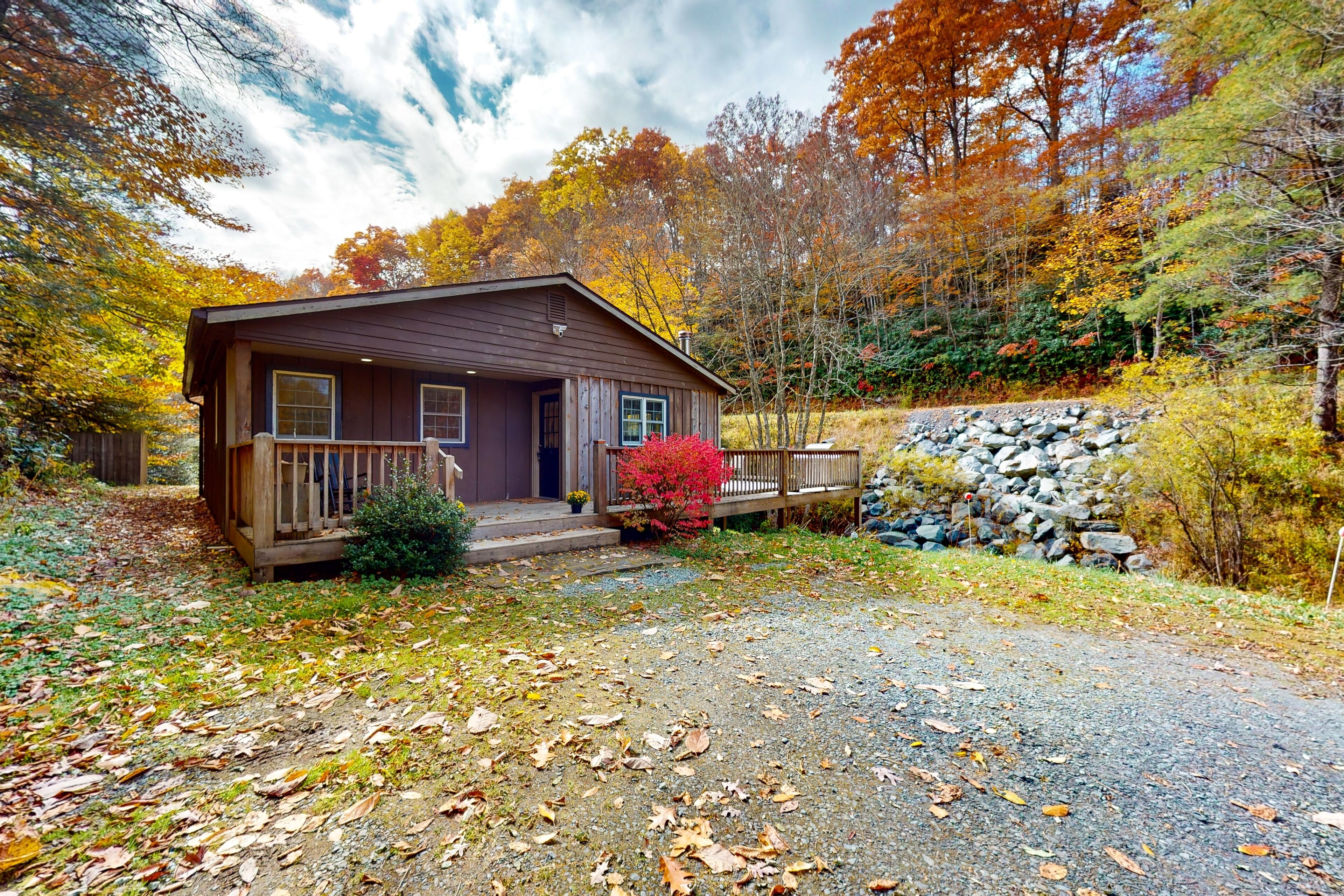 Streamside cottage on +2 acres with large deck, firepit, fireplace, & W/D