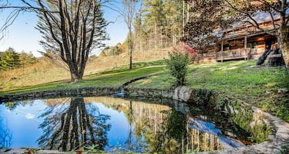 Lovely forest retreat with fireplace, full kitchen, front porch, and pond views
