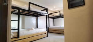 A room with bunk beds, each with a mattress and a pillow. - G Hotel powered by Cocotel (San Juan)