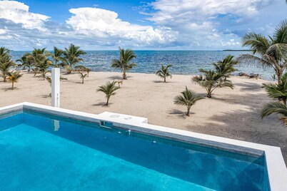 Luxurious beachfront home with private pool, rooftop grill, and sea views