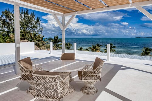Luxurious beachfront home with private pool, rooftop grill, and sea views