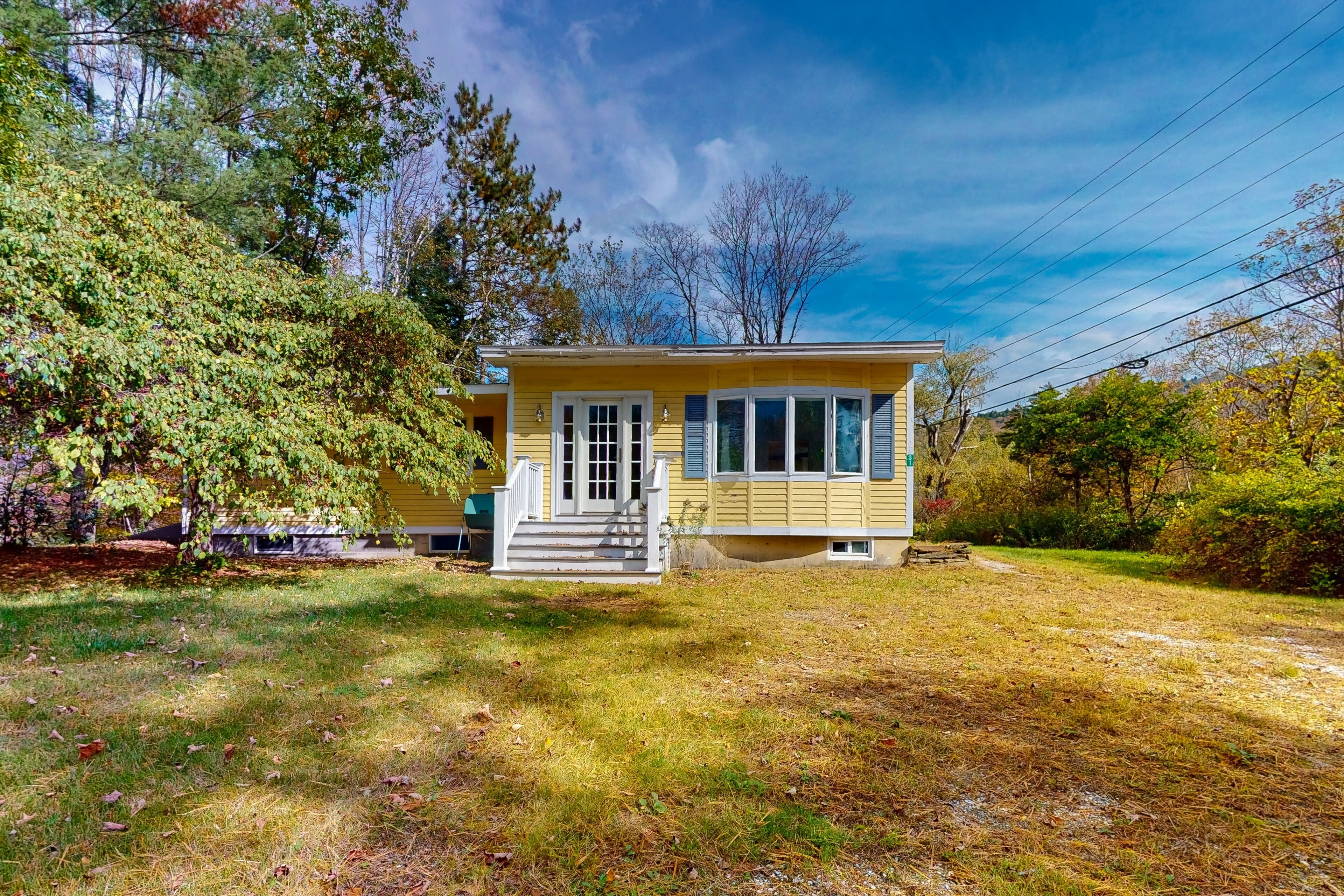 Okemo Valley home with river view, private yard, & wood-burning fireplace