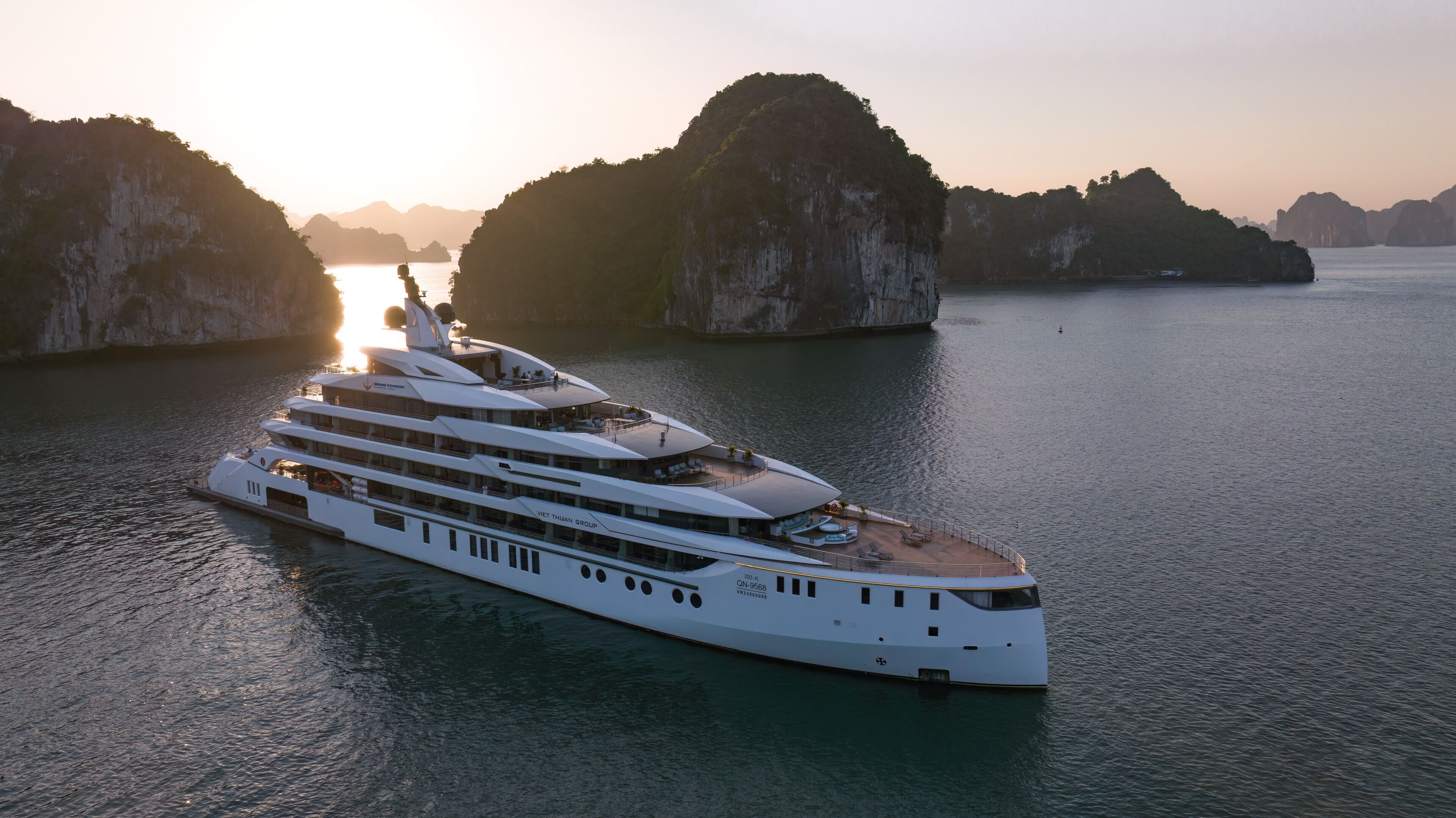 A large, multi-deck yacht with a spacious deck area and multiple levels of accommodation.