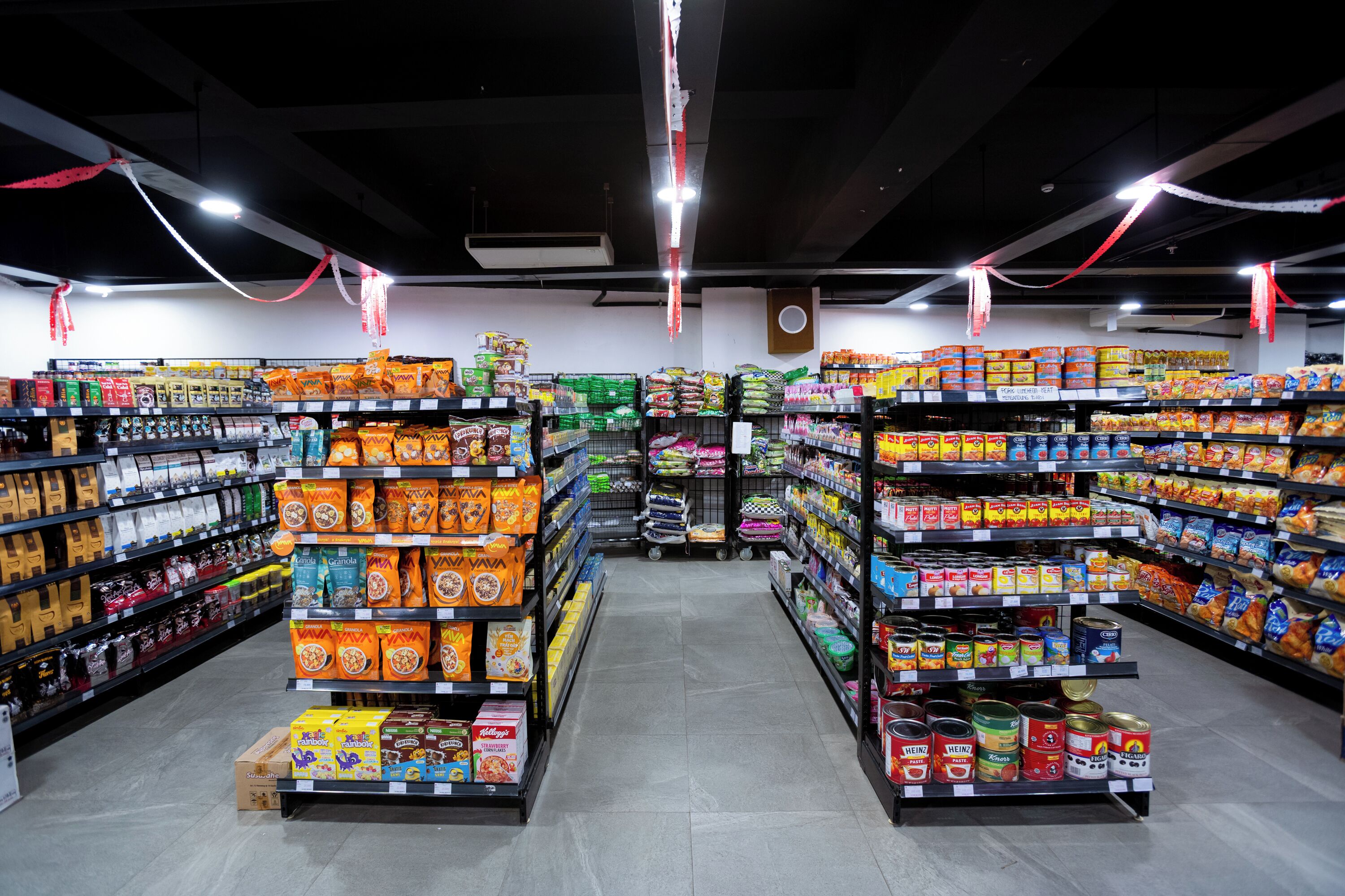 A grocery store aisle with shelves stocked with various food items.