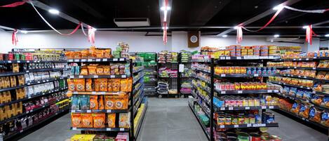 A grocery store aisle with shelves stocked with various food items.