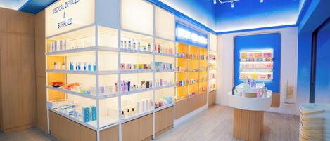 Tienda luminosa con estantes llenos de suministros médicos y un mostrador con productos.