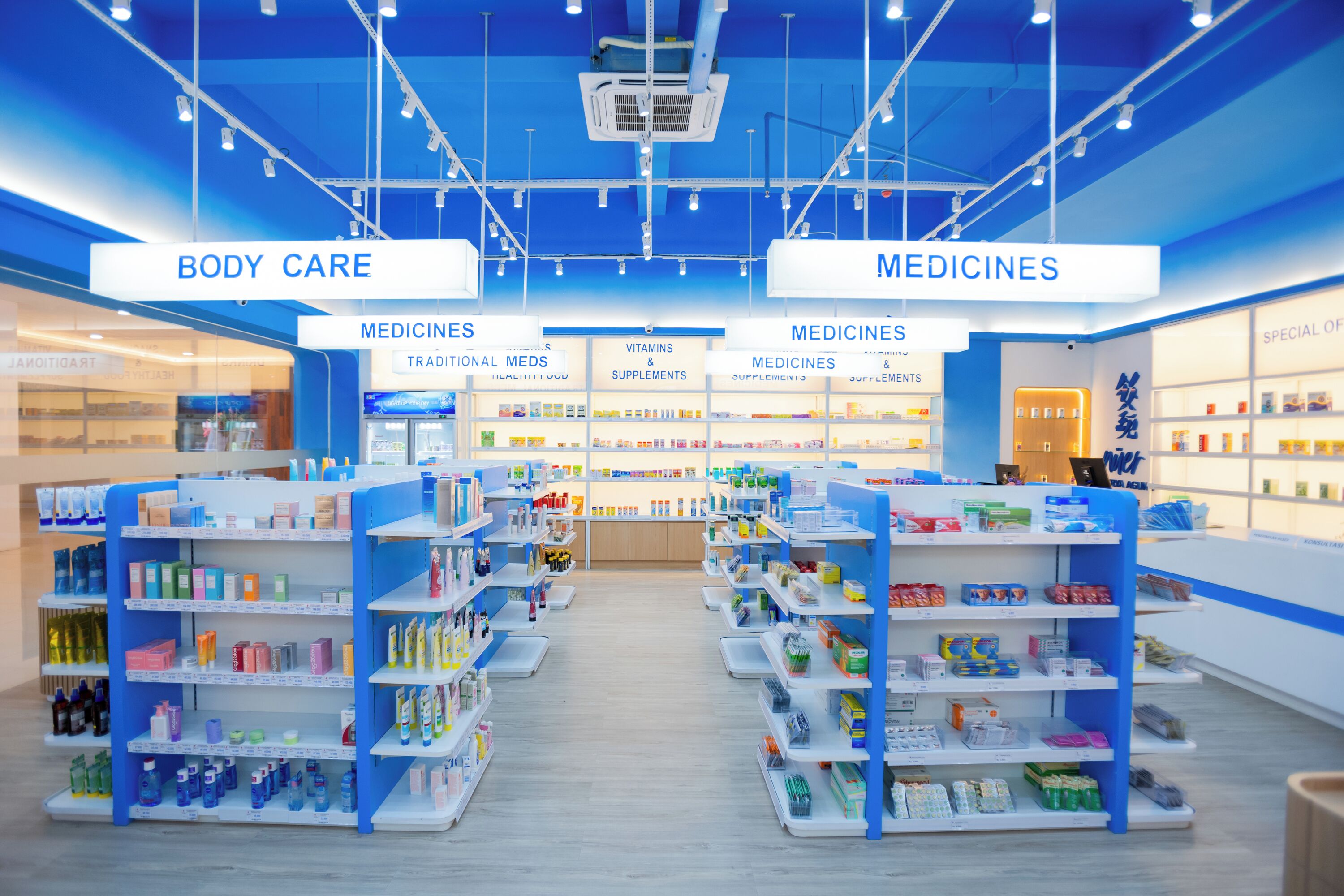 A brightly lit pharmacy with shelves stocked with various health products, including vitamins and supplements.