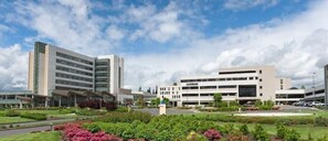 Contemporary building with a flat roof and well-manicured grounds.