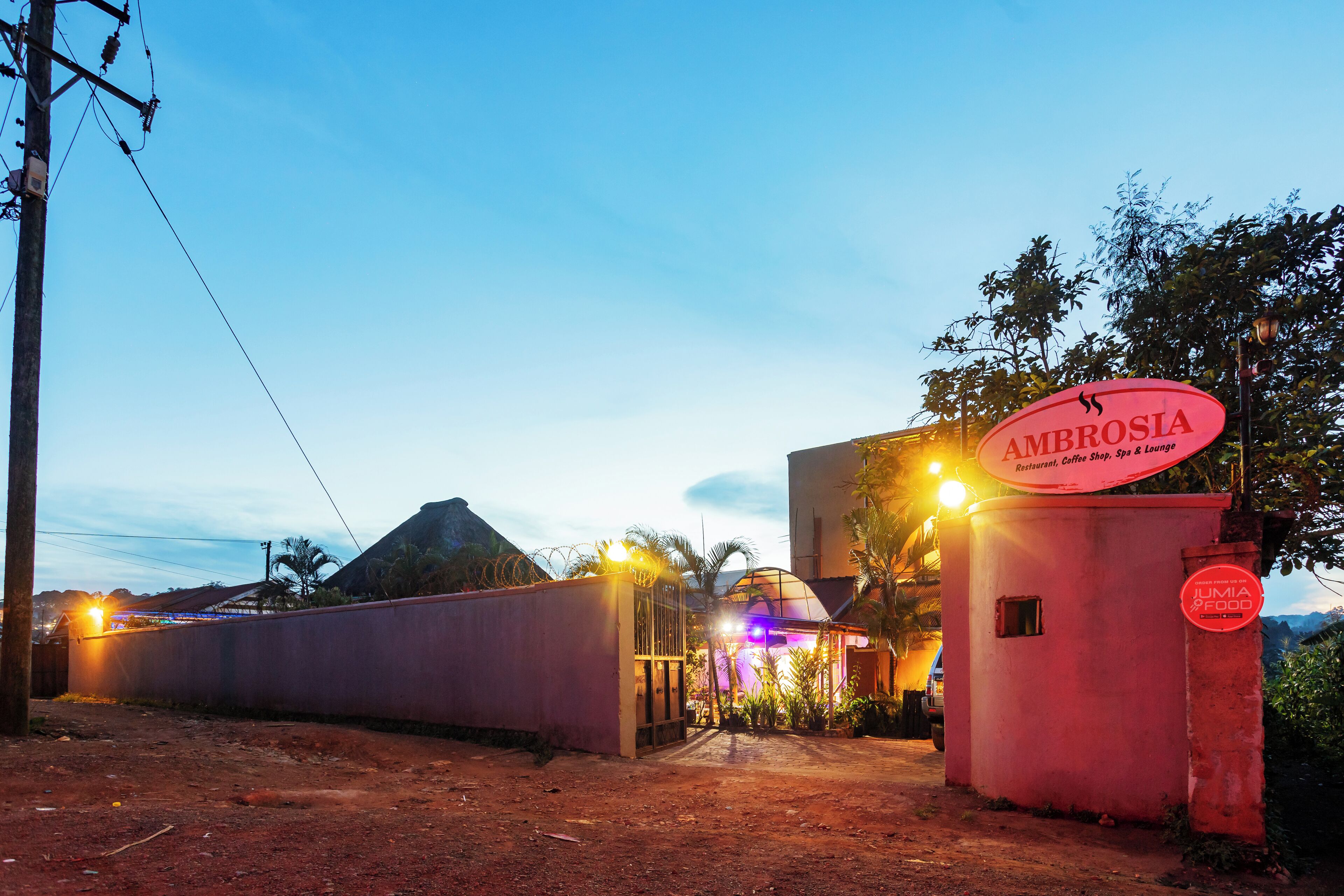 A building with a sign reading "AMBROSIA Restaurant, Coffee Shop, Spa & Lounge."