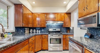 Dog-friendly home on 1/2 acre with creek access, game room & 2 fireplaces
