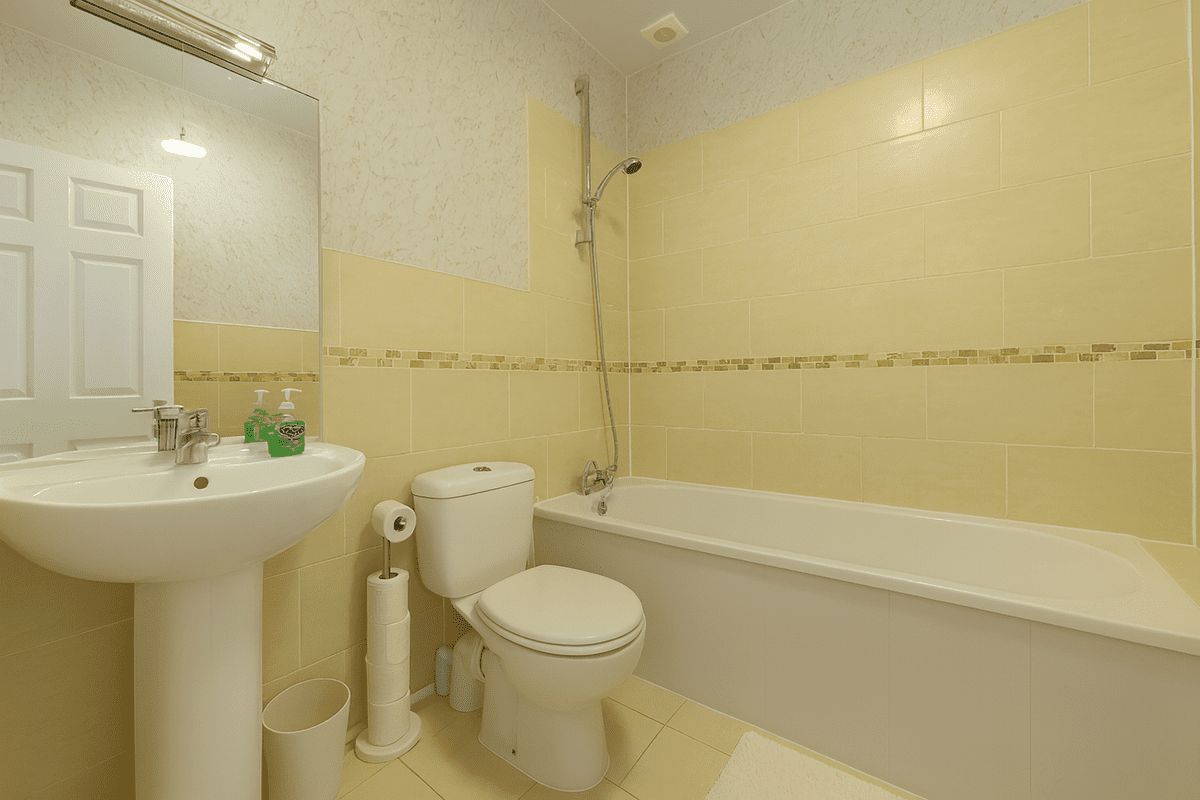 A bathroom with a sink, toilet, and bathtub.