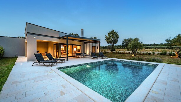 A modern house with a swimming pool, outdoor seating, and a well-maintained garden. - Stunning home in Pula (Pula)