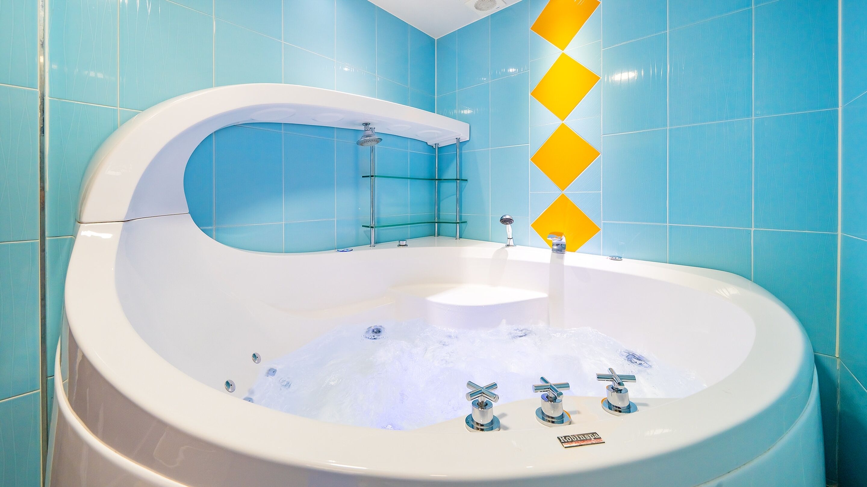 A modern bathroom with a freestanding bathtub, glass shelves, and a showerhead.