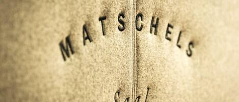 Primer plano de una superficie texturizada con las palabras “MATSCHELS” y “Salat” en relieve.