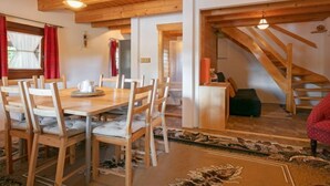 A wooden dining area with a table and chairs, a staircase, and a view of the outdoors. - Pod Liščím kopcem 4+4 by Interhome (Dolni Branna)