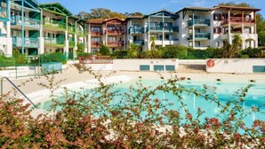 A hotel with multiple balconies, a swimming pool, and a clear sky. - Les Terrasses d'Arcangues by Interhome (Arcangues)