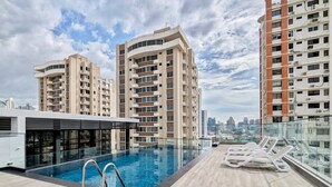 A rooftop pool area with a view of the city skyline, surrounded by high-rise buildings. - w* | Glorious 1BR w/ Terrace in San Francisco (Panamá)