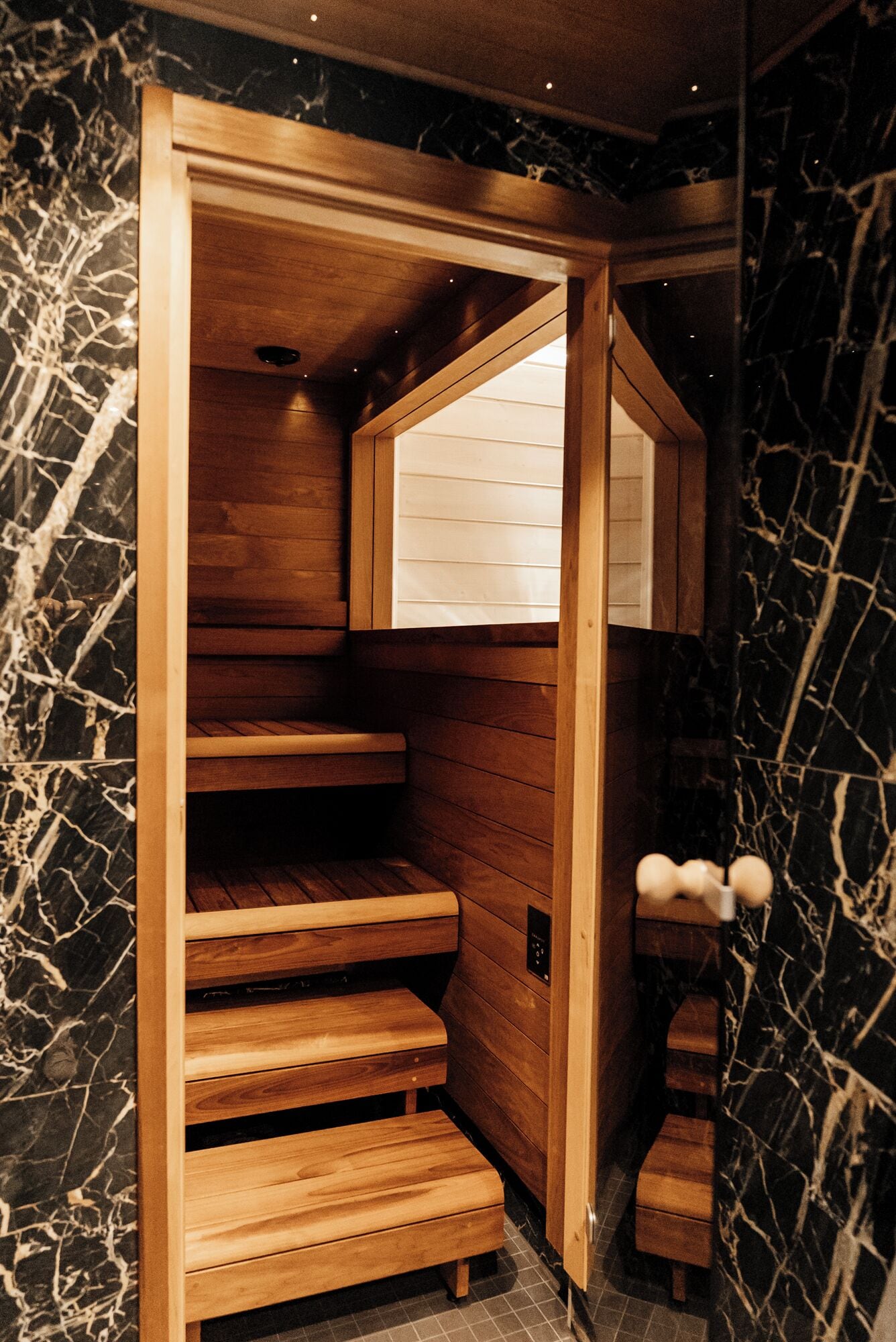 A sauna with wooden benches and a window.