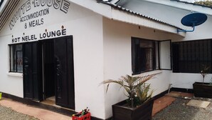 A building labeled "WHITE HOUSE ACCOMMODATION & MEALS" with a sign for "KOT NEEL LOUNGE". - WHITE HOUSE LOUNGE & GUEST HOUSE (Eldoret)