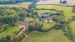 An aerial view of a rural property with a large house, multiple barns, and extensive fields. - Hearts Delight Cottage by Bloom Stays -  a holiday let that sleeps 4 guests  in 2 bedrooms (Canterbury)