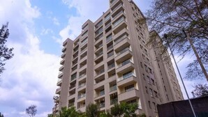 A high-rise building with multiple balconies and a clear sky. - Nairobi's Oasis: Pool, Gym, & Modern Comforts (Nairobi)