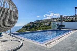 A swimming pool with a view of a hillside town and the sea. - Quinta do Feliz, a Home in Madeira (Ponta do Sol)