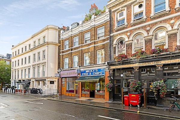 A street view with buildings, including a fish and chips shop, a pub, and a restaurant.