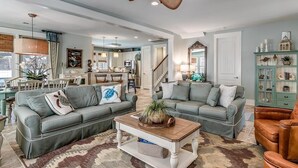 A spacious living room with two grey sofas, a coffee table, and a green cabinet. - Unrivaled Luxury 3BR Home with Private Pool (North Myrtle Beach)