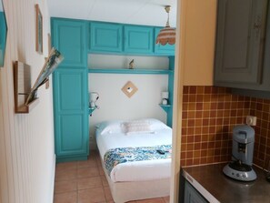 Cozy retreat with a single bed, kitchenette, and modern amenities.