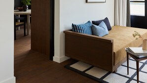 A modern bedroom with a large bed, a desk, and a dining area. - Morgan & Mees Rotterdam (Rotterdam)
