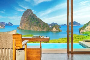 A modern room with a view of a mountainous coastline and a pool. - Beyond Skywalk Nangshi (Takua Thung)