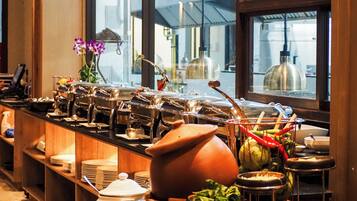 A buffet setup with various food items and utensils.