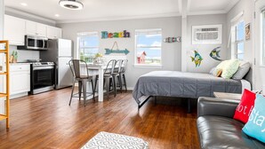 Um espaço compacto com cozinha compacta, área de refeições e quarto.