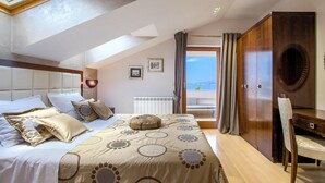 A bedroom with a bed, a desk, and a view of the sea. - Beautiful home in Okrug Donji (Okrug Donji)