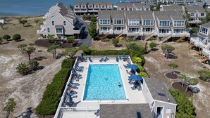 A resort with a swimming pool, multiple buildings, and a beach view. - Close to the beach with community pool! (Lewes)