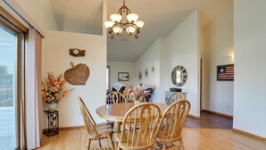 A dining area with a wooden table and chairs, a chandelier, and decorative wall art. - 5 Mi to Dtwn: Pet-friendly 'wheatland Twin' Home! (Fargo)
