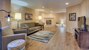 A cozy living room with a sofa, armchairs, a fireplace, and a television. - 5 Mi to Dtwn: Pet-friendly 'wheatland Twin' Home! (Fargo)