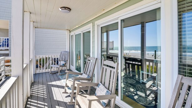 A covered deck with outdoor seating and a view of the beach. - Oceanfront Murrells Inlet Home w/ Beach Access! (Murrells Inlet)