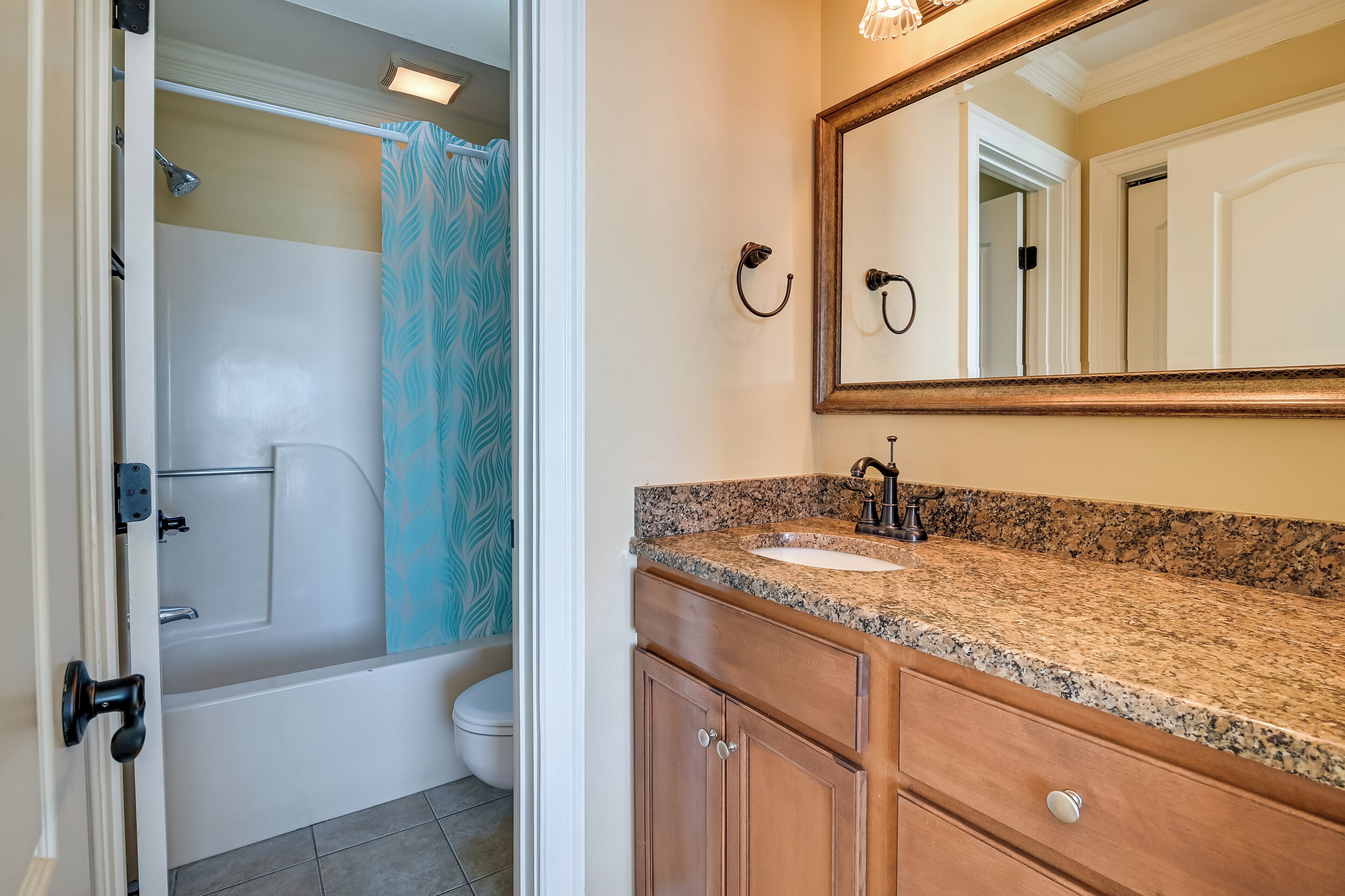 A bathroom with a bathtub, toilet, and sink.