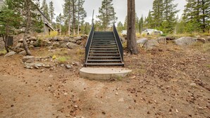 A staircase leading up to a building surrounded by trees and rocks. - Mountain Condo w/ Fireplace in Kirkwood Ski Resort (Kirkwood)