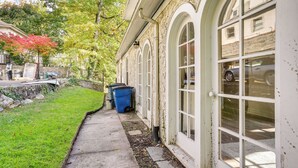 A building with arched windows and a concrete pathway. - Historic Mamaroneck Guest House - Walk to Harbor! (Mamaroneck)