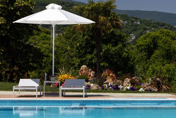 Seasonal outdoor pool, open 10:00 AM to 6:00 PM, pool umbrellas