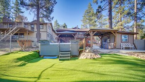 A property with a well-maintained lawn, a covered outdoor area, and a building with multiple levels and balconies. - 1 Mi to Lake: Home w/ Hot Tub & Gazebo in Big Bear (Big Bear Lake)