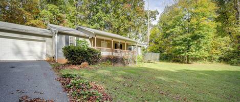 A single-story house with a front porch, a garage, and a well-maintained lawn.