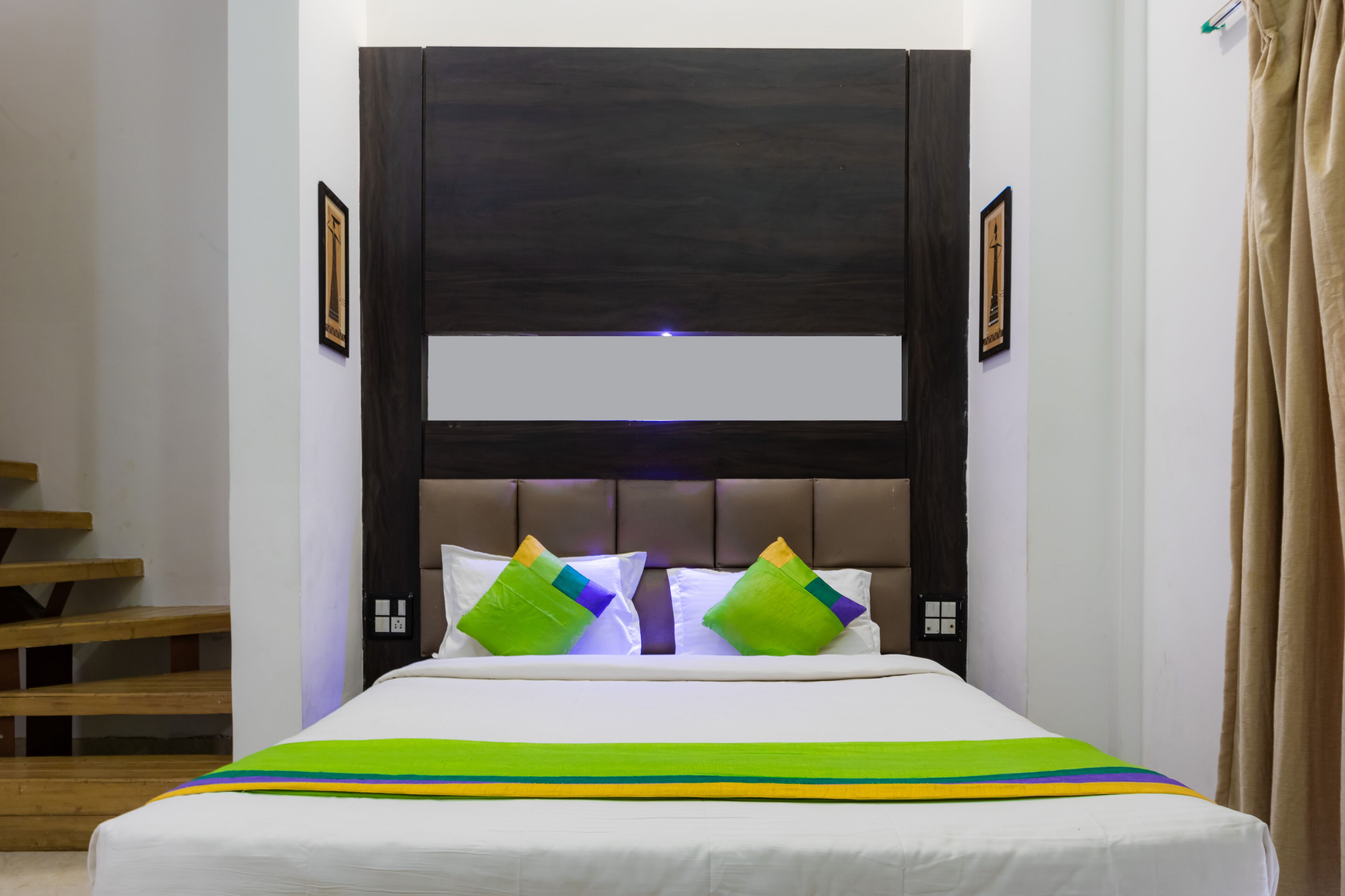 A bed with a headboard, pillows, and a striped bedspread.