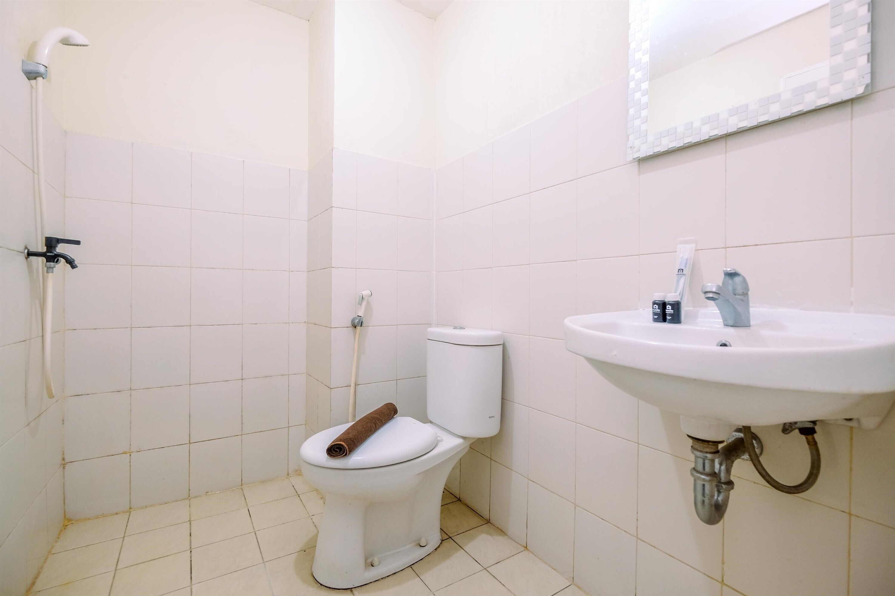 A bathroom with a toilet, a sink, and a shower.